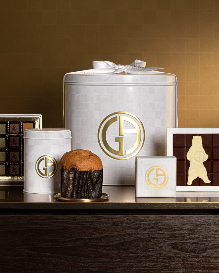 Photograph of lots of boxes of chocolates with an open box in the middle with different types of chocolates in various flavours