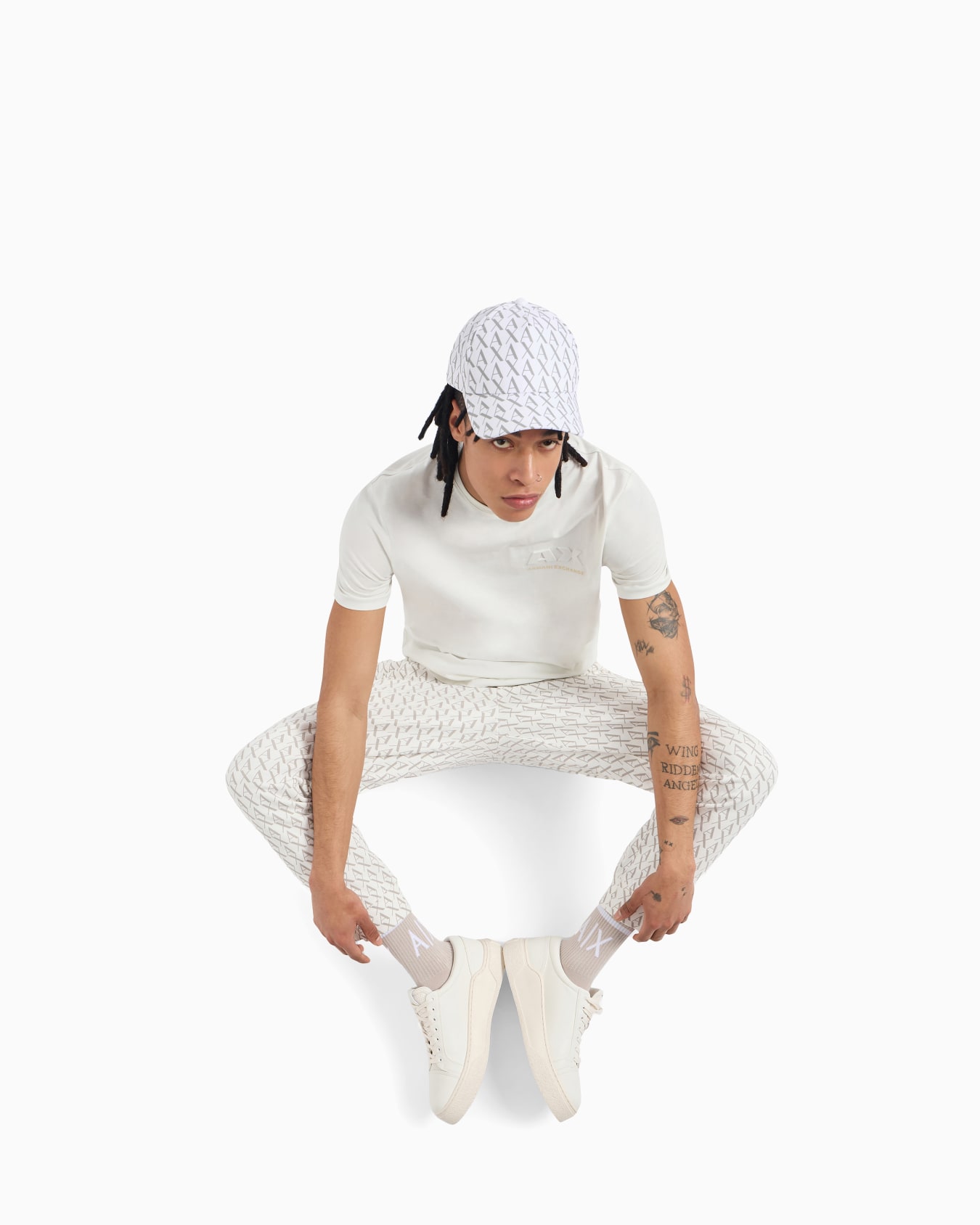 Jogger pants in fabric with allover logo pattern Slide 1